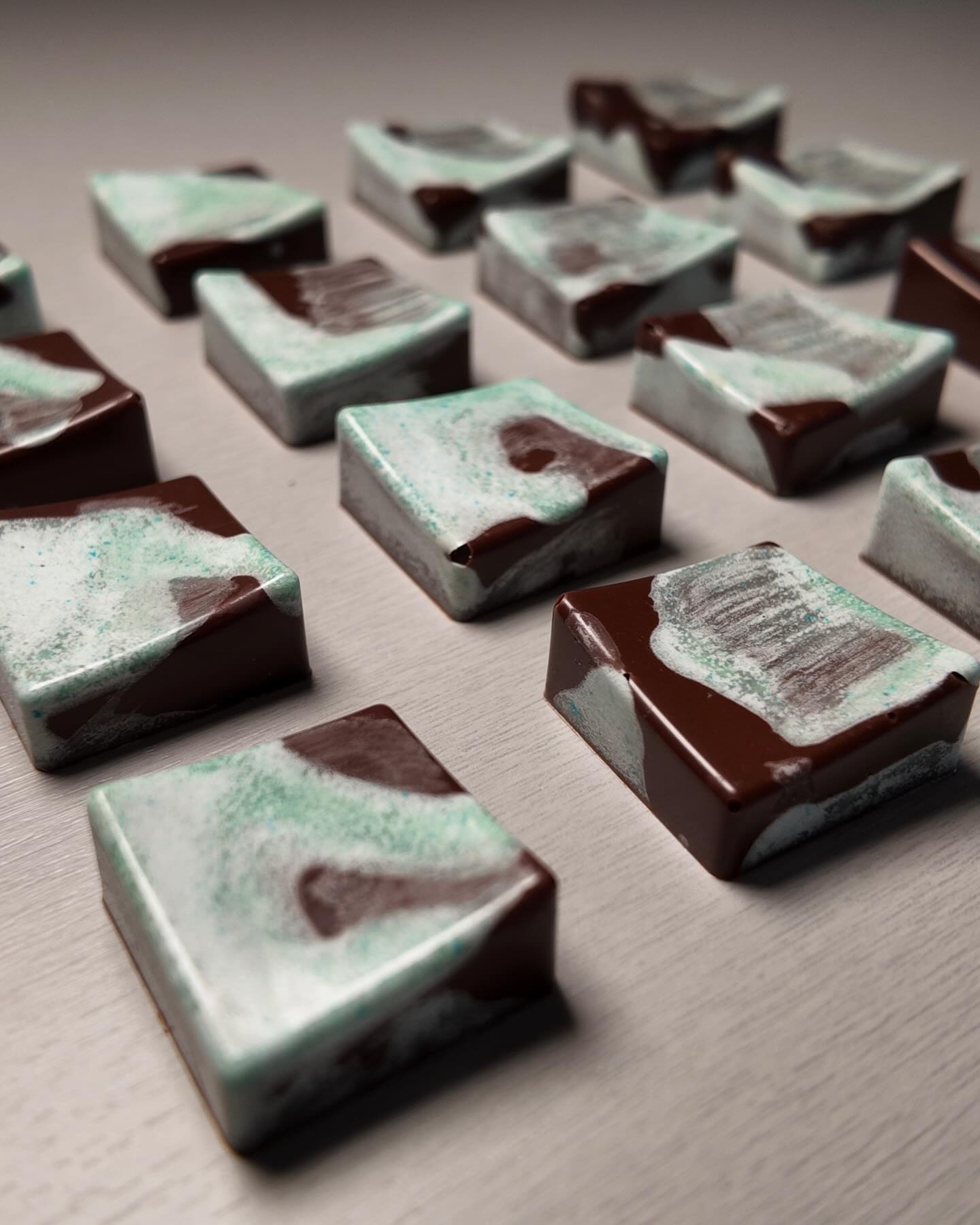 Close-up of glossy marbled chocolate bonbons