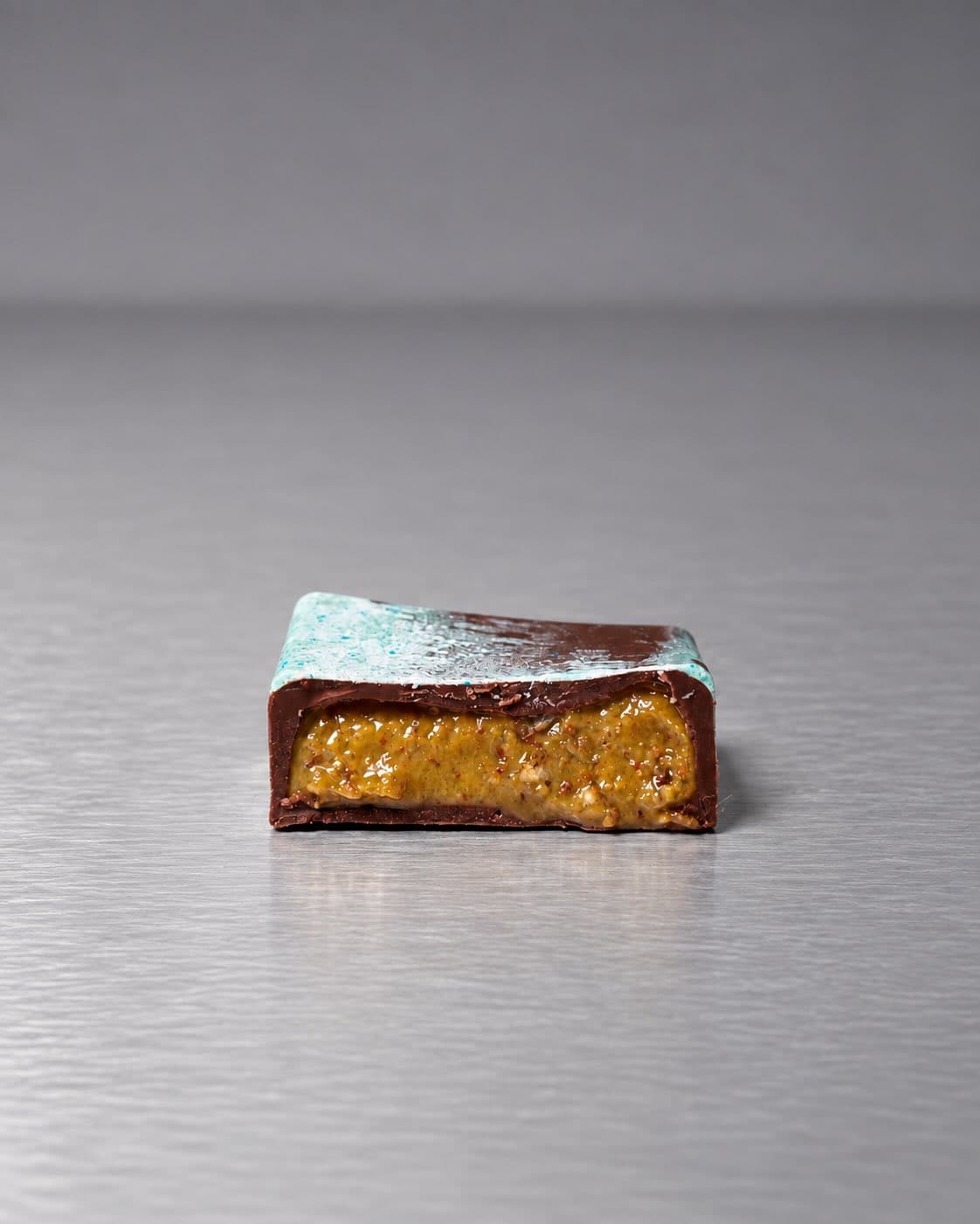 Bonbon cut open to show the praline filling