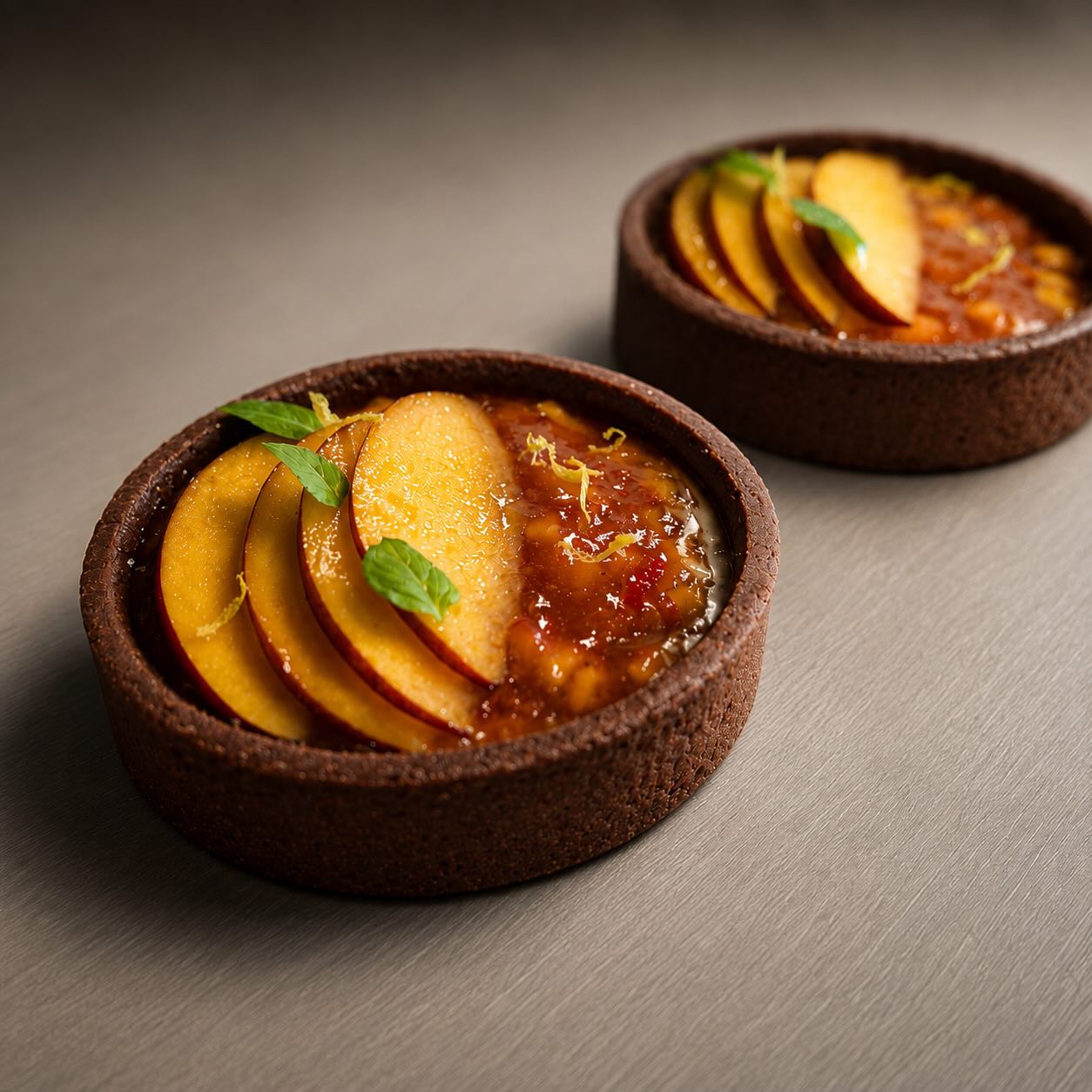 Peach and basil tartlet on chocolate pate sucree
