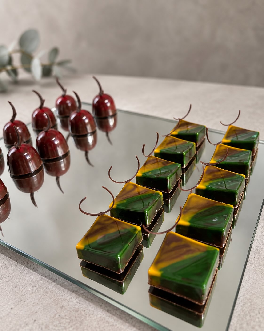 Petits fours and cherry pralines on a mirror